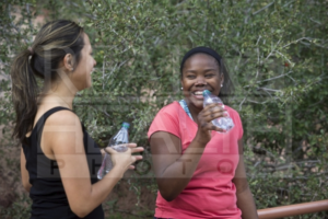 Two Young Female Friends Drinking Water